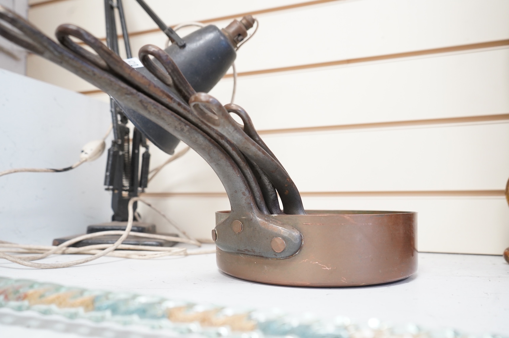 A graduated set of five copper saucepans, largest 40cm wide